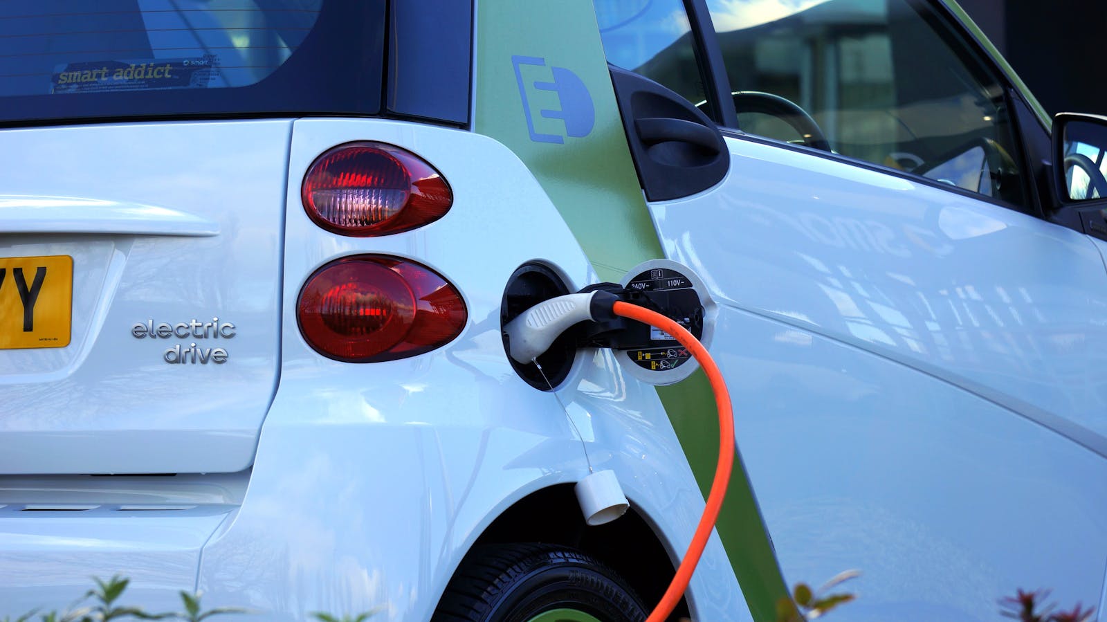 Electric vehicle plugged in for charging