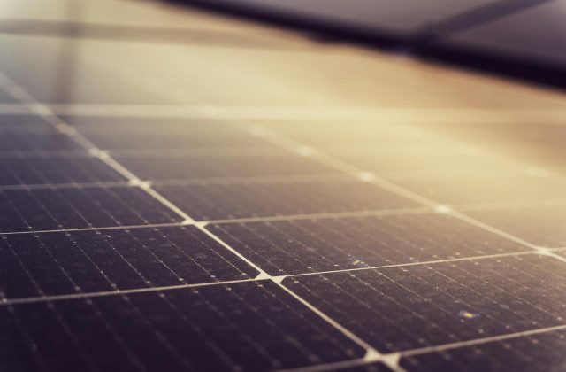 Checklist clipboard next to a solar panel