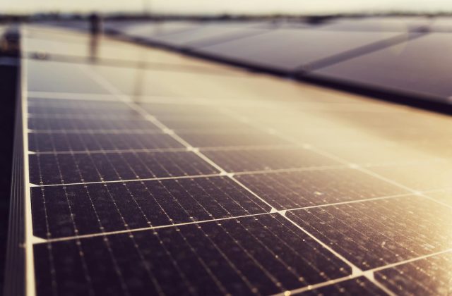 Close-up of solar panel cells against a blue sky
