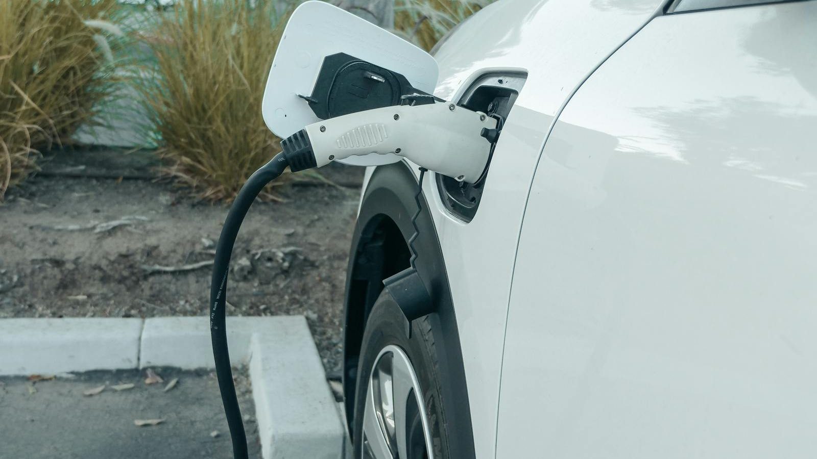 Person plugging in their electric car at home