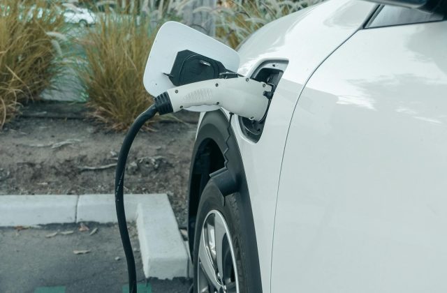 Person plugging in their electric car at home