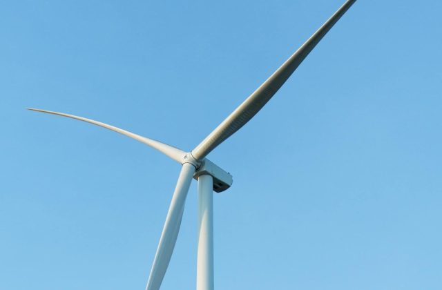 Wind turbines and solar panels side by side