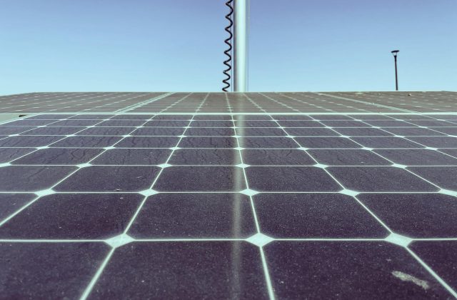 Sun shining on a row of rooftop solar panels