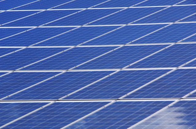 Hand cleaning the surface of a solar panel