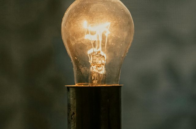 Person inspecting a home thermostat