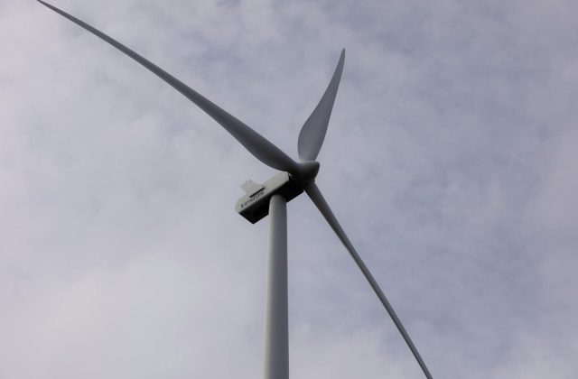 Wind turbine spinning over a field