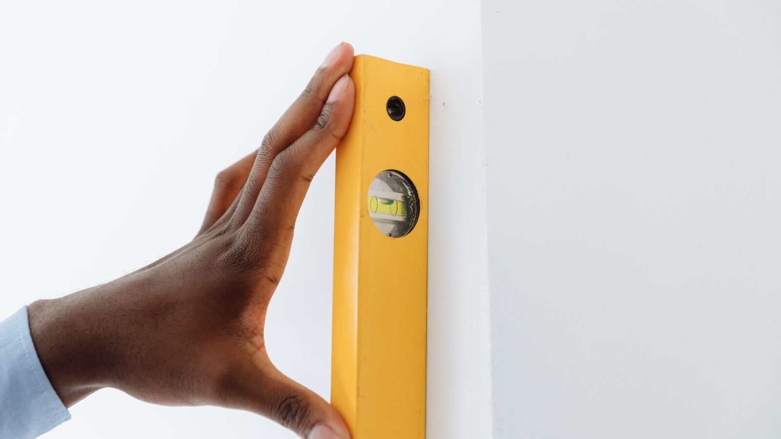 Wall-mounted ductless mini-split head installed above a window inside a residential room