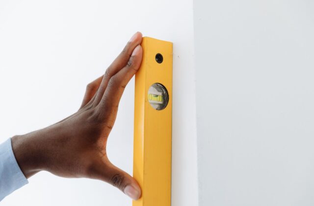 Wall-mounted ductless mini-split head installed above a window inside a residential room