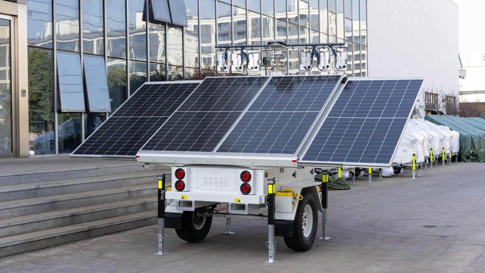 Portable solar power station with folding solar panel set up on a home porch during a winter power outage
