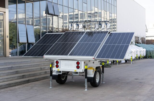 Portable solar power station with folding solar panel set up on a home porch during a winter power outage